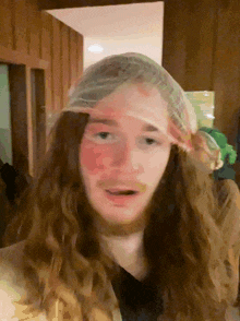 a man with long hair and a bandana on his head