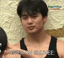 a man in a black tank top with the words river on shuvee above him