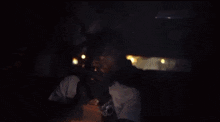 a man is smoking a cigarette in a car .