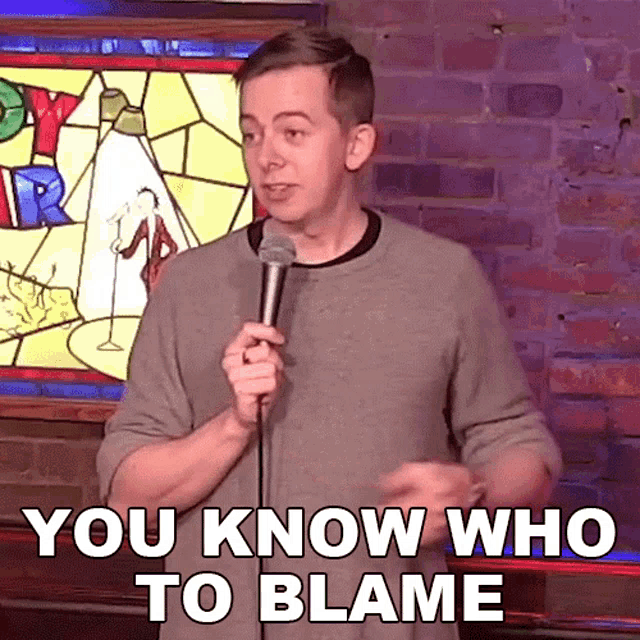 a man stands in front of a microphone and says 