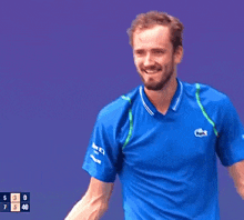 a man in a blue shirt with a lacoste logo on it