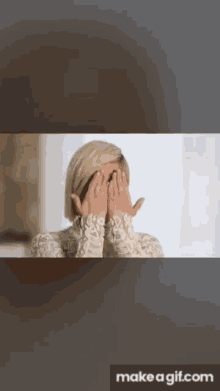 a woman in a white dress is covering her eyes with her hands