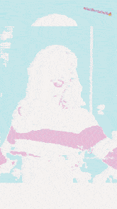 a woman in a pink and white striped shirt with a tiktok logo on the bottom right