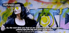 a woman wearing sunglasses stands in front of a wall with graffiti on it and a quote from kulfyapp.com