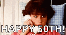 a woman is laying in bed talking on a cell phone and the words `` happy 50th ! ''