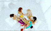 a woman with a tattoo on her arm is sitting next to another woman in a white tank top