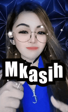 a woman wearing glasses and a blue shirt with the word m kasih written on it