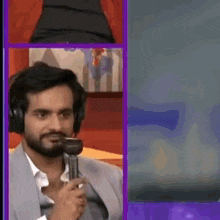 a man wearing headphones is holding a microphone in his mouth