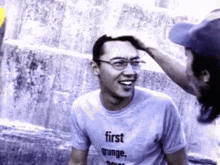 a man wearing glasses and a t-shirt that says first grunge