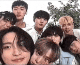 a group of young men are posing for a selfie together .