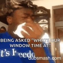 a man is crying while wearing a blue shirt that says ' being asked whats our window time at ' on it