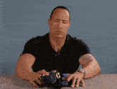 a man sitting at a table with a stuffed animal in his hands