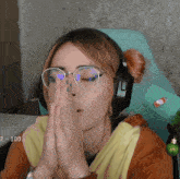 a woman wearing glasses and headphones with the number 100 on the bottom