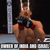 a man wearing ufc gloves stands in front of a crypto.com banner