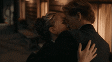 a man and a woman are hugging and kissing each other
