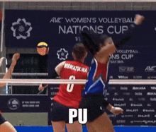 a volleyball player with the number 2 on her jersey stands in front of a sign that says women 's volleyball nations cup