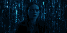 a girl in a white shirt is standing in a dark room