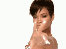 a woman with short hair is pointing her finger at the camera