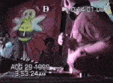 a video of a man playing a guitar in front of a bee .