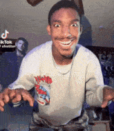a man wearing a shirt that says ' afrotian ' on the front
