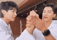 two men are shaking hands in front of a sign that says ' forris ' on it