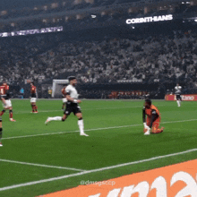 a soccer game is being played in a stadium that says corinthians