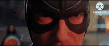 a close up of a man 's face wearing a superhero mask .