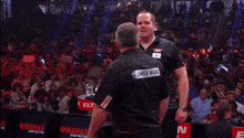 a man in a black shirt with the word james on it