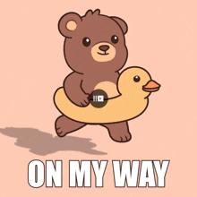 a brown teddy bear is carrying a yellow rubber duck and the words on my way are below it