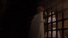 a girl with pink hair is behind bars with a sword