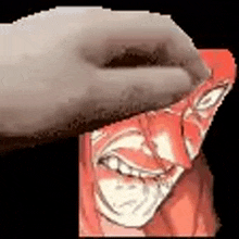 a person is holding a piece of paper with a drawing of a man 's face on it .