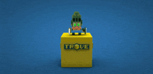 a yellow cube with trove written on it