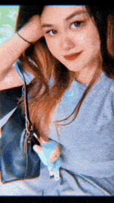 a woman is taking a selfie while holding a purse and a stuffed animal .