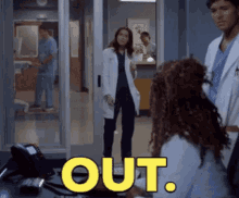 a group of doctors are standing in a room with the word out written in yellow