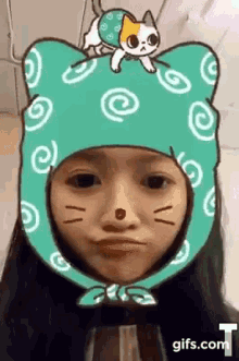 a woman wearing a cat hat with a cat on top