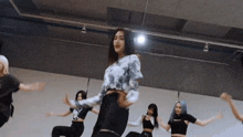 a group of people are dancing in a dance studio .