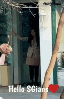 a woman standing in a doorway with a red heart and the words hello sgians