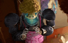 a cartoon character with a blue helmet and a pink shirt with the letter l on it