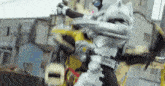 a man in a superhero costume is fighting another man in a city street .