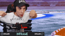 a man wearing headphones and a hat is playing a video game with the name inframe on the bottom right