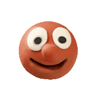 a clay face with a tongue sticking out and a winking eye