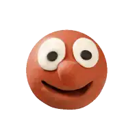 a clay face with a tongue sticking out and a winking eye