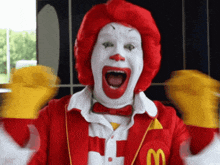 a man dressed as mcdonald 's ronald mcdonald with his mouth wide open