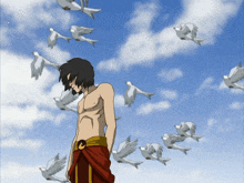 a man stands in front of a flock of white birds