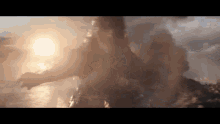 a close up of a person standing in front of a body of water surrounded by smoke .
