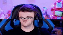 a man wearing glasses and headphones is making a face