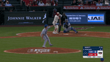 a baseball game is being played with an ad for johnnie walker