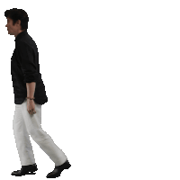 a man in a black shirt and white pants walking