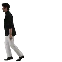 a man in a black shirt and white pants walking