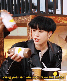 got7 kim yugyeom eat strawberry milk on the table